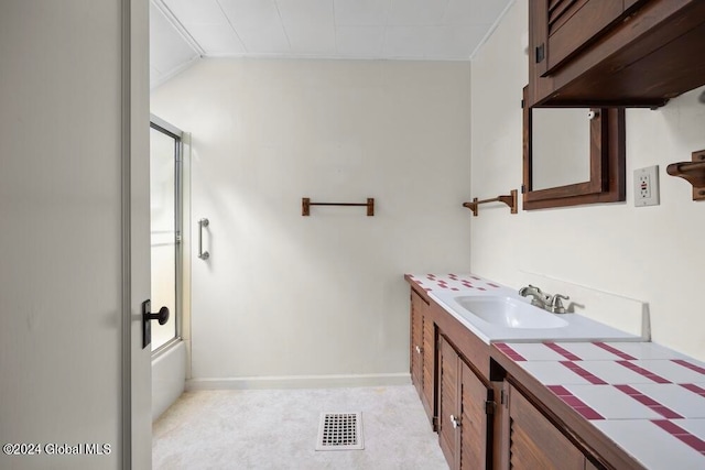 bathroom featuring shower / bath combination with glass door and vanity