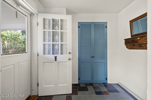 entryway featuring dark tile patterned flooring