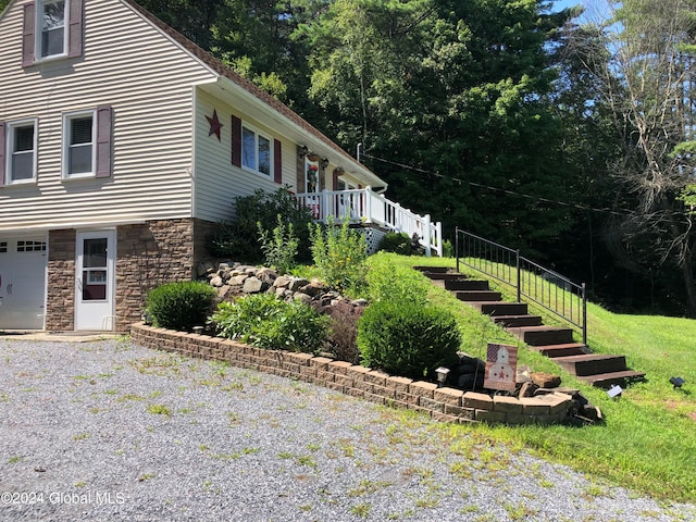 view of home's exterior featuring a garage and a lawn