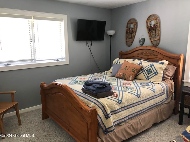 bedroom featuring light carpet