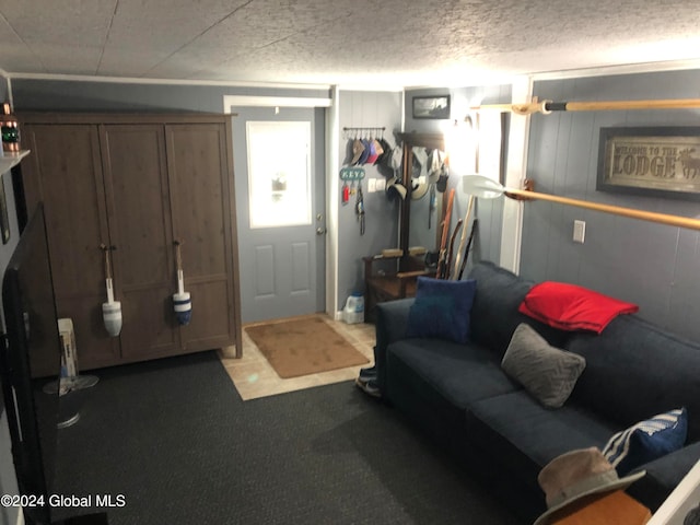 living room with a textured ceiling and dark carpet