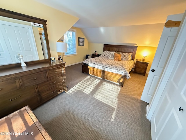 carpeted bedroom featuring lofted ceiling and a closet