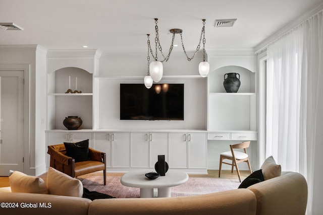 living area featuring crown molding, wood finished floors, and visible vents