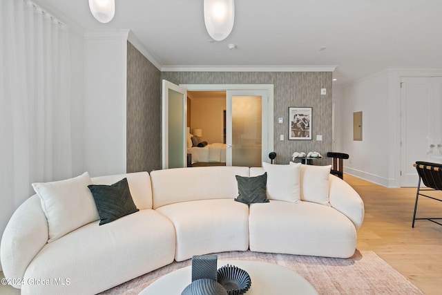 living room with light wood-style flooring, ornamental molding, electric panel, wallpapered walls, and baseboards