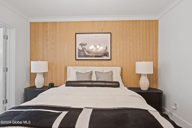 bedroom featuring crown molding and baseboards