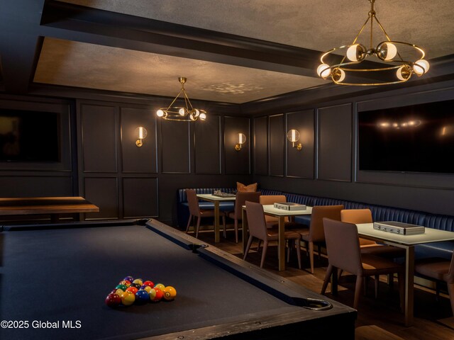 rec room with a chandelier, billiards, and a decorative wall