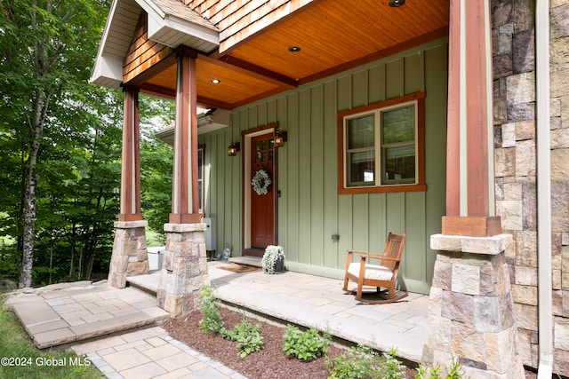 view of exterior entry with covered porch