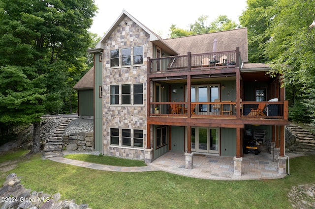 back of property with a yard and a patio area