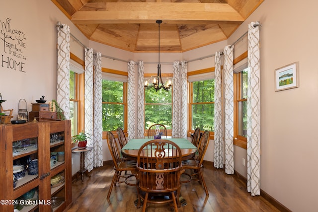 dining area with a notable chandelier, a raised ceiling, and dark hardwood / wood-style floors