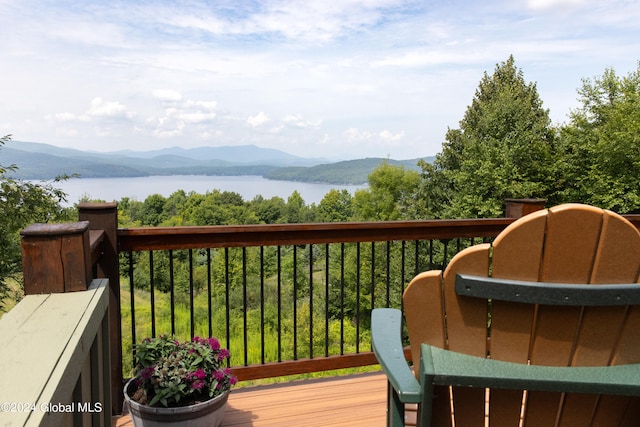 deck with a water and mountain view