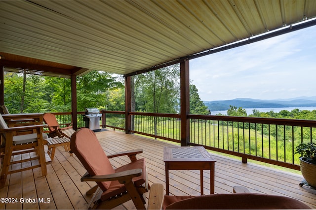 wooden deck featuring a mountain view and area for grilling