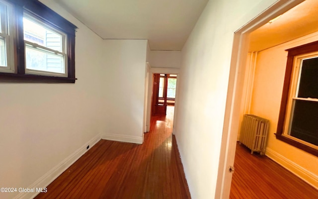 hall featuring dark hardwood / wood-style floors and radiator