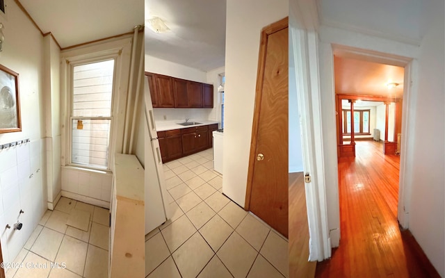 kitchen with light tile patterned floors, sink, and a healthy amount of sunlight