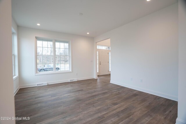 spare room featuring dark wood-type flooring