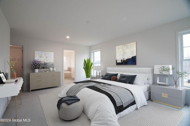 carpeted bedroom featuring ensuite bathroom and recessed lighting