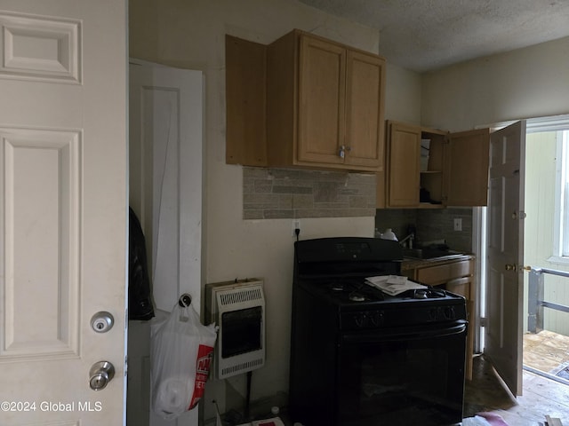 kitchen featuring sink, black gas stove, backsplash, heating unit, and light brown cabinetry