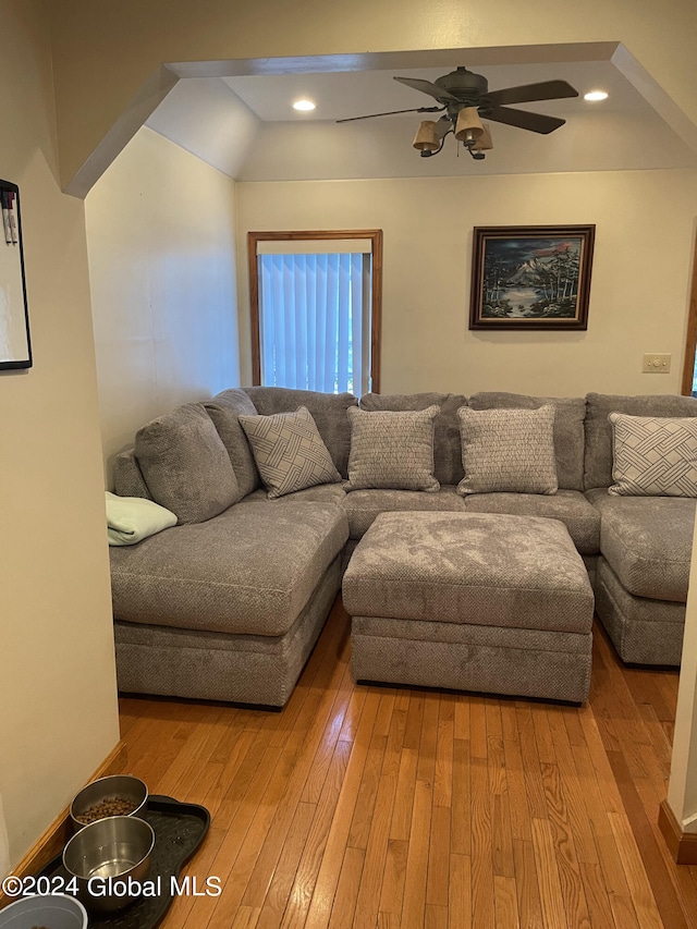 living room featuring light hardwood / wood-style flooring and ceiling fan