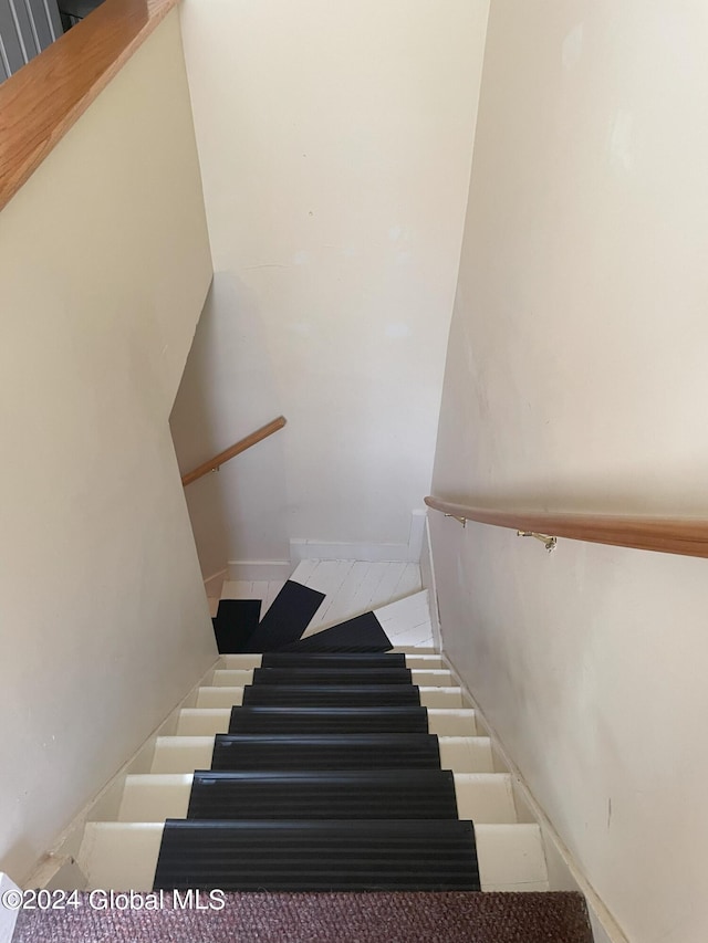 staircase featuring tile patterned floors