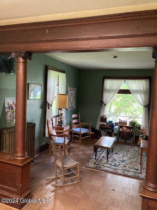 living room with ornate columns