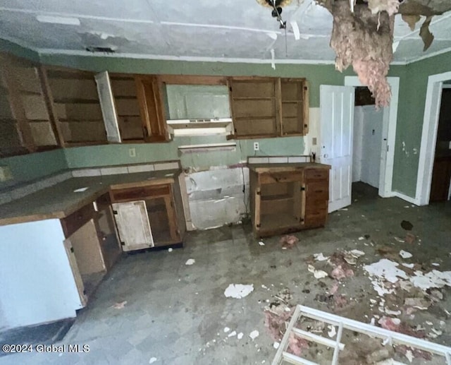 kitchen featuring tile counters and brown cabinets