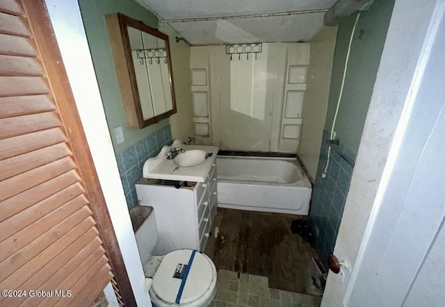 bathroom featuring tile walls, toilet, and vanity
