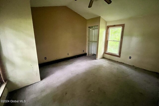 spare room featuring ceiling fan and lofted ceiling