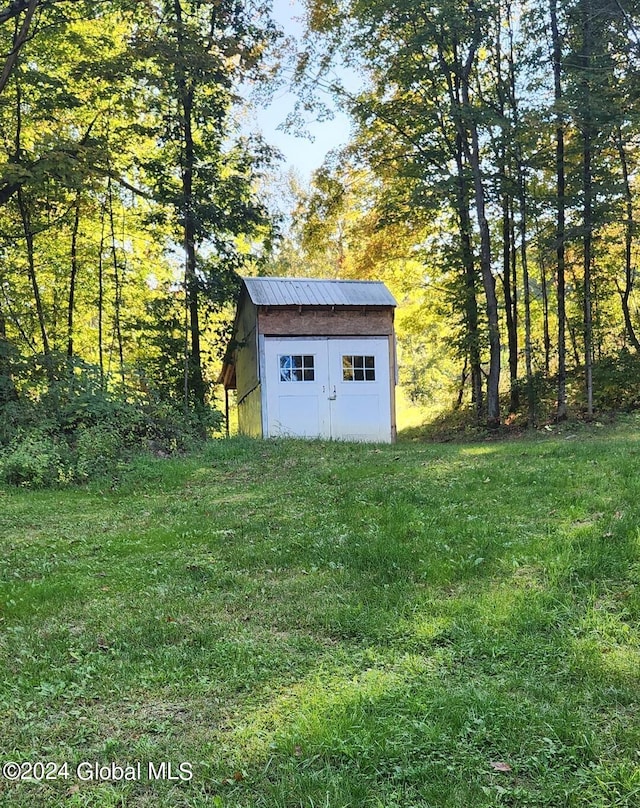 view of outbuilding with a lawn