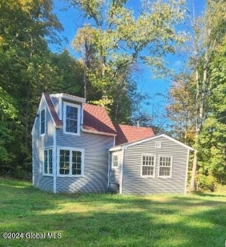 back of house with a lawn