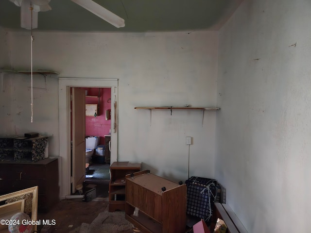 misc room with ceiling fan and concrete flooring