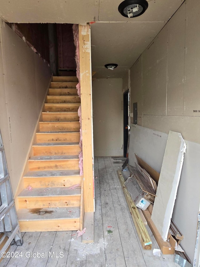 staircase with hardwood / wood-style floors