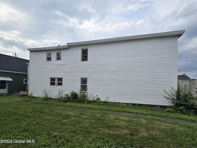 view of side of property with a lawn