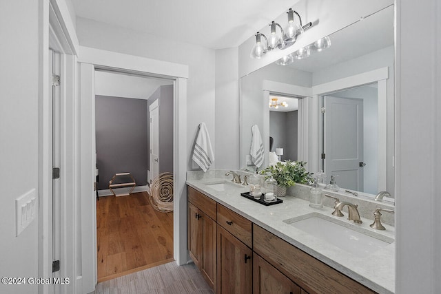 bathroom with double sink vanity and hardwood / wood-style flooring