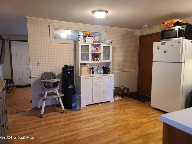 kitchen featuring white refrigerator, white cabinets, and light hardwood / wood-style floors