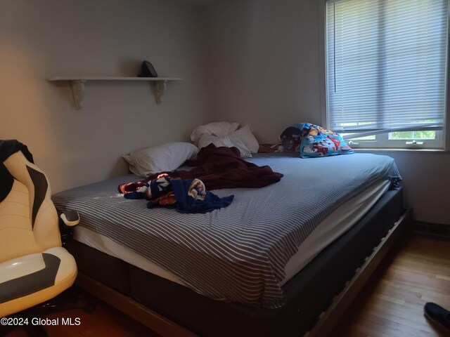 bedroom with wood-type flooring