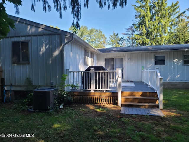 21 Foxhall Dr, Saratoga Springs, NY 12866 - rear view of property with cooling unit, board and batten siding, and a deck