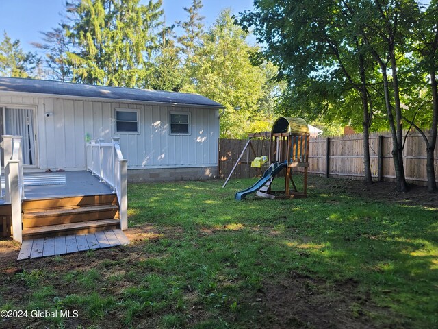 view of yard with a playground and a deck