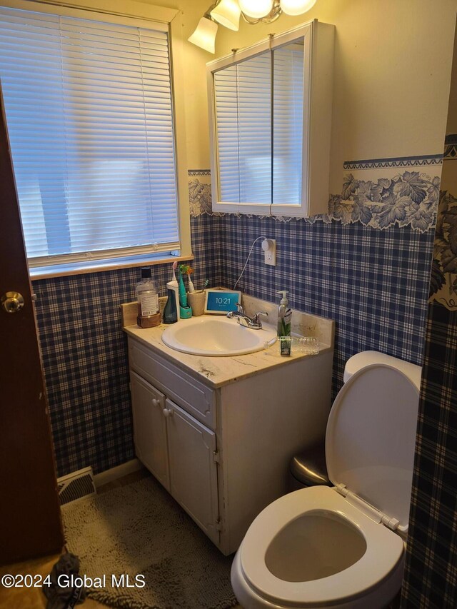 bathroom featuring vanity and toilet