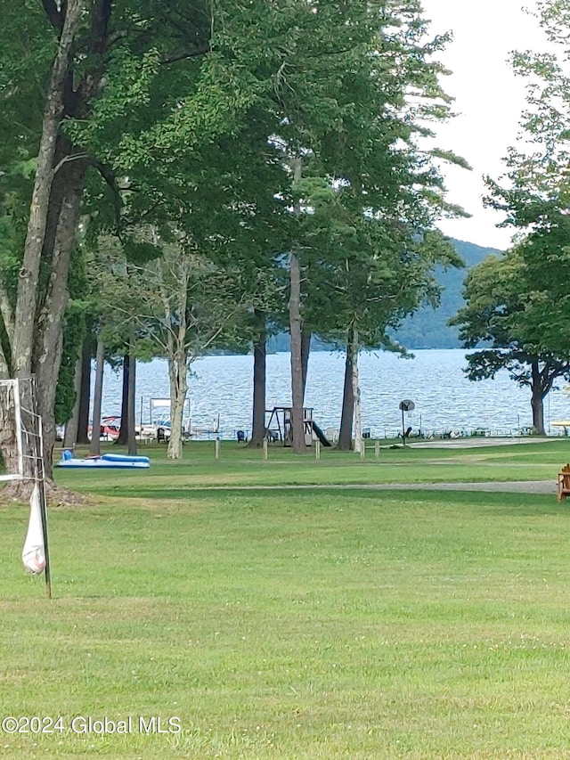 surrounding community featuring a water view and a yard