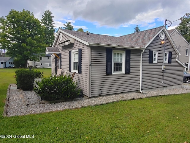 view of side of property with a yard