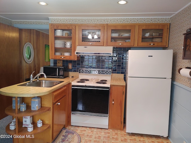 kitchen with sink, white appliances, and decorative backsplash