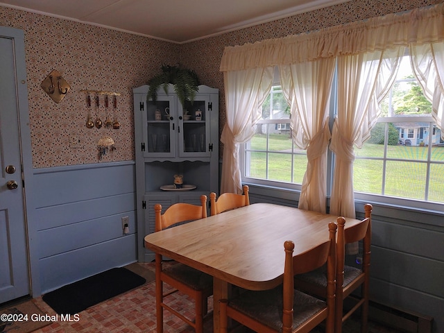 dining space featuring crown molding