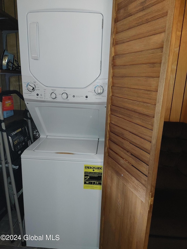 clothes washing area featuring stacked washer / drying machine