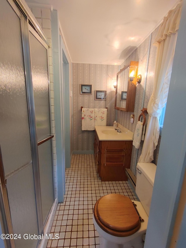 bathroom featuring vanity, toilet, a shower with shower door, and tile patterned flooring