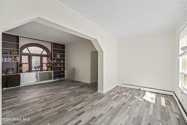 interior space featuring crown molding, a wealth of natural light, and wood-type flooring