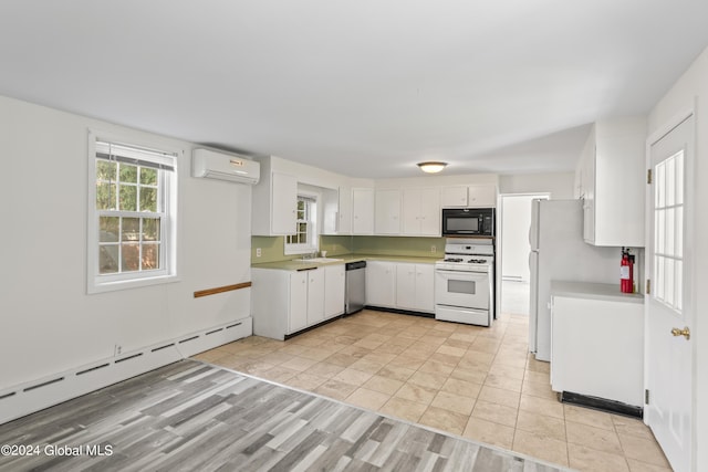 kitchen featuring a wall mounted air conditioner, white cabinetry, sink, a baseboard heating unit, and white appliances