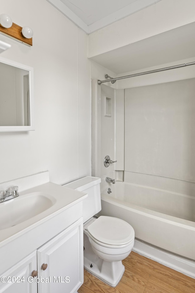 full bathroom featuring hardwood / wood-style flooring, vanity, shower / washtub combination, and toilet