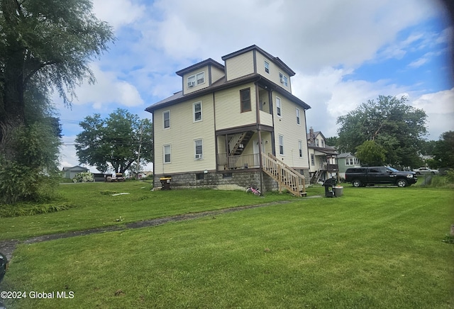 rear view of house with a yard