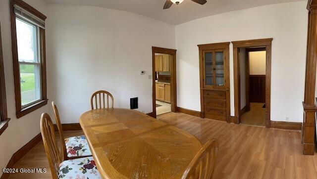 dining area with ceiling fan and light hardwood / wood-style floors