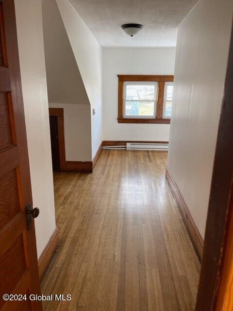 bonus room featuring light hardwood / wood-style flooring and baseboard heating