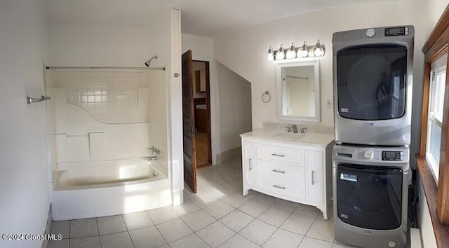 bathroom featuring stacked washer and clothes dryer, vanity, and tile patterned floors